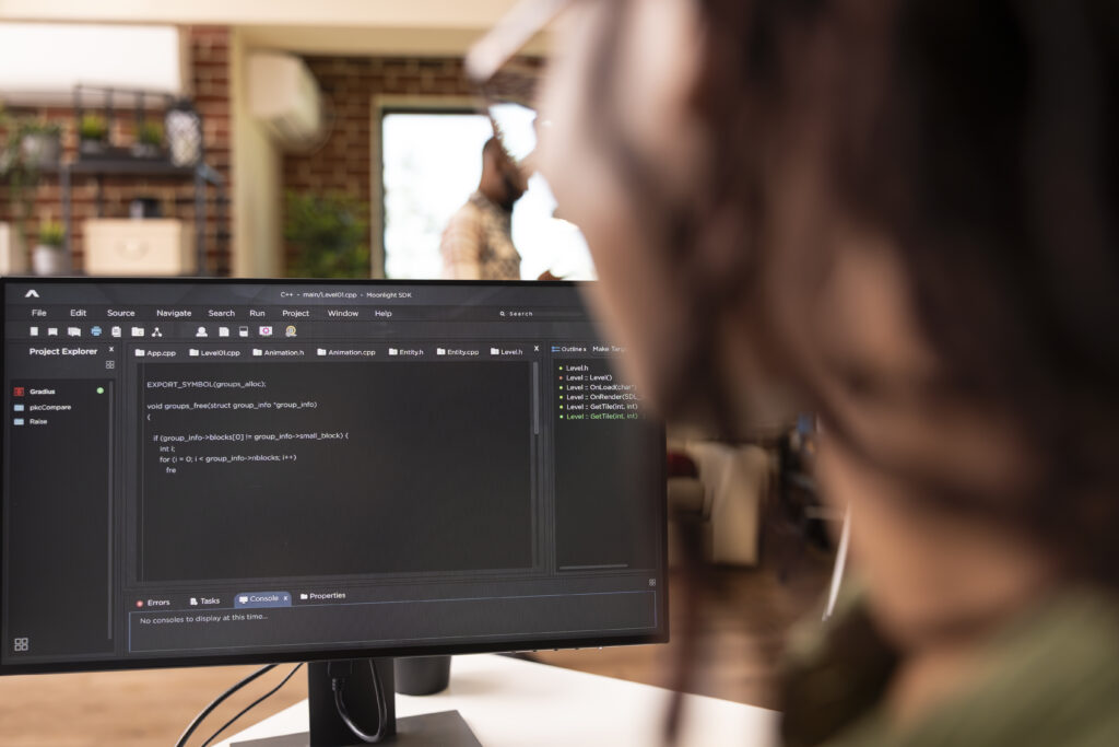 Closeup of black freelance developer using desktop monitor